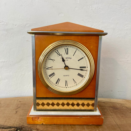 Introducing a truly unique piece, the vintage art deco clock by William Widdop est 1883. This stunning design features a vivid aluminium form, an acrylic matt burnt orange colour front and back, and a pyramid top panel.