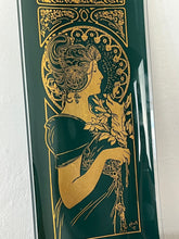 Load image into Gallery viewer, Vintage large glass tray in the deep green background with Alphonse mucha the feather picture in gold. Mucha portrays a young woman surrounded by lush foliage and delicate feathers. The figure is depicted in profile, and she wears a flowing gown.
