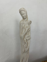 Load image into Gallery viewer, The sculpture is carved from white alabaster stone. The woman&#39;s face is delicate and feminine, with high cheekbones, a small nose and full lips. She is depicted in a flowing gown. Next to her is a shallow pot with beautiful detail on the outside.
