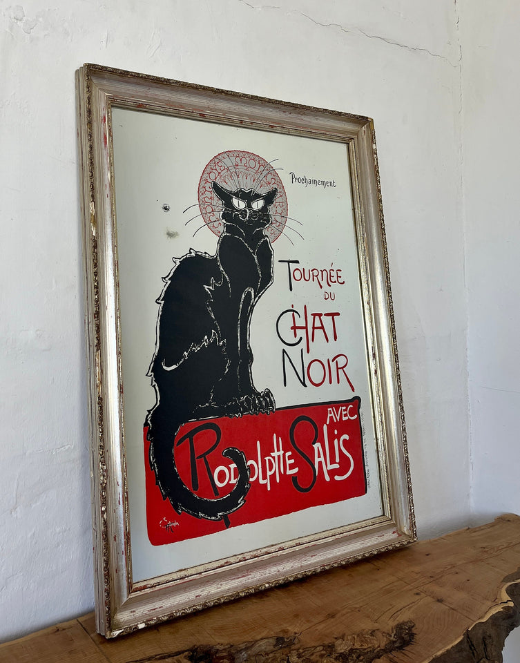 The poster features a black cat with piercing yellow eyes. The cat&#39;s silhouette is set against a bold, vibrant background, often in red, black, and yellow shades. Surrounding the cat, there is a flurry of information about the touring shows