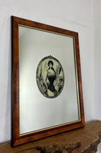 Load image into Gallery viewer, The mirror depicts a glamorous Victorian lady in an oval design with a noir effect, and it includes intricate details and a provocative finish. The walnut frame is of high quality and dates back to the 1920s.
