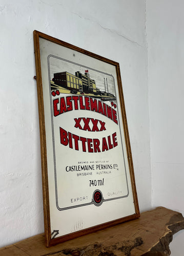 This mirror has a bold font in vivid red tones, a detailed factory picture, additional information about the Australian beer company, and a dual-line border. The mirror comes with a lighter-coloured wooden frame.