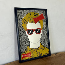 Load image into Gallery viewer, The mirror features a striking design that showcases a fashionable individual with a red bow and sunglasses dressed in a vibrant yellow outfit. Their hair frames the mirror in a TV-like effect for a unique look.
