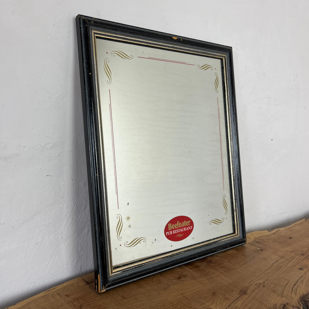 It features an oval logo of the famous pub branding in a matt red, an intricate Victorian-style gold border, and a darker wooden frame.