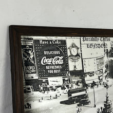 Load image into Gallery viewer, The artwork depicts a beautiful landscape design of Piccadilly Circus in a noir effect. The vintage image showcases the famous London landmark with its advertisement screens and the road that features vintage black cabs and iconic buses

