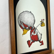 Load image into Gallery viewer, The image is printed on the back of the mirror and shows through to the front, featuring the sad duck in vibrant red and yellow, holding his hobo bag with a noir arched background.
