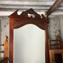 Load image into Gallery viewer, Stunning period antique featuring a long bevelled mirror set within a mahogany frame with expertly shaped, detailed, carved, and added carved pediment to the top.
