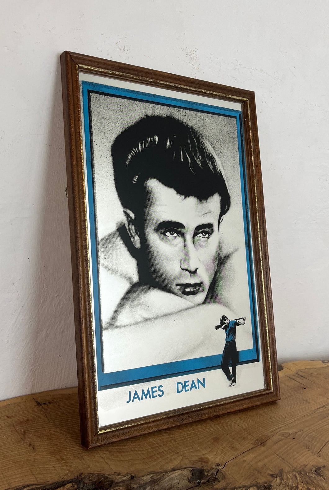 This is a vintage mirror featuring James Dean, the iconic movie actor. It is a unique collectible item that showcases excellent detail in depicting the actor's signature pose and famous look.