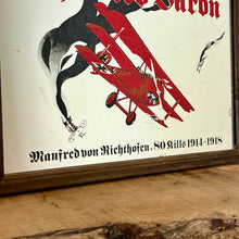 Load image into Gallery viewer, Vintage Red Baron plane mirror featuring vivid picture of the plane in bright colours with a battle scene over the mirror and bold font describing the pilot name and the dates, more historical detail about the piece further down.
