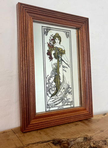 Beautiful Mucha collectables piece features an elegant lady with a stylish dress in an matt gold finish flowing down with a vivid robe holding a large bouquet with a beautiful floral background and the vibrant, intricate border.