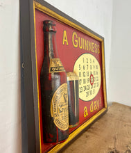 Load image into Gallery viewer, Stunning Guinness vintage calendar plaque showing detailed model of the foreign extra bottle and glass with marvellous matt tones with an aged label, the piece design in a intricate detailed finish, hand painted fonts.
