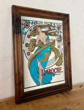 Load image into Gallery viewer, Stunning art nouveau mirror featuring a glamorous lady wearing an elegant dress and scarf with an azure blue design with her hair flowing across the mirror in the background continues with the flower design with an intricate pattern.
