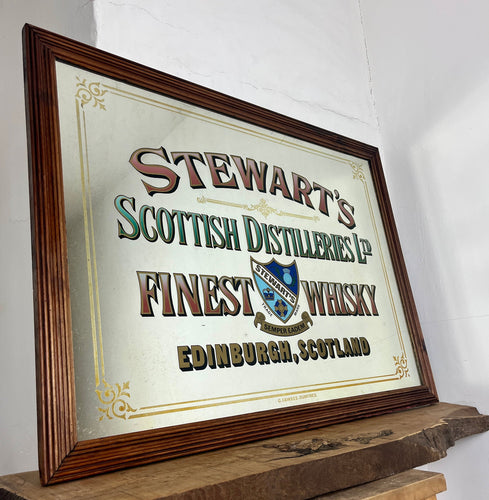 Stunning mid-century Stewart’s Edinburgh Scotch whisky mirror featuring a perfect image of the historical Scottish design, elegant Victorian style font in a selection of different styles with vivid finish.